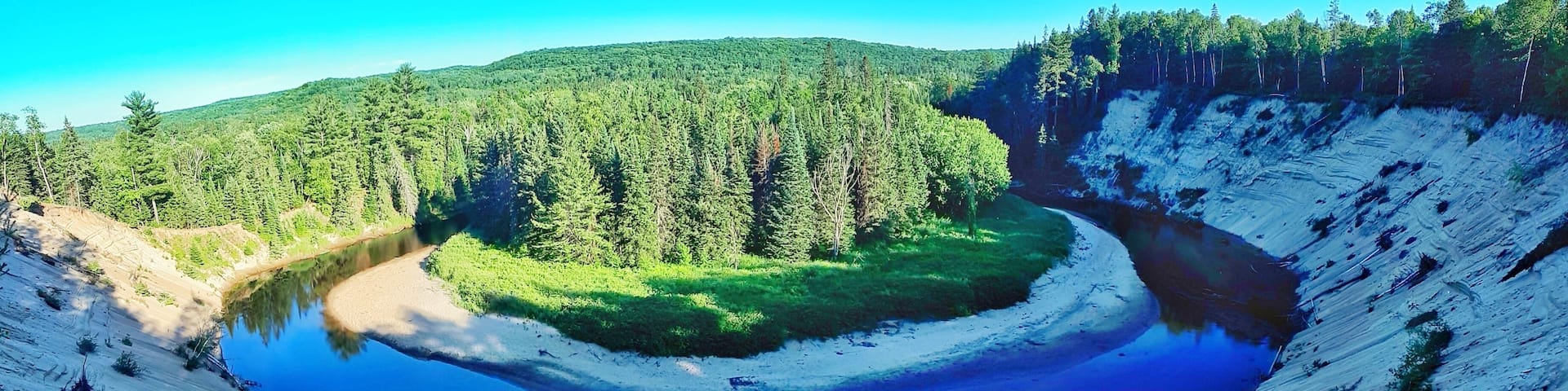 A glacial lake surrounded by forested hills.