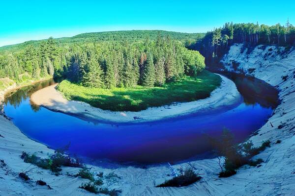 A glacial lake surrounded by forested hills.