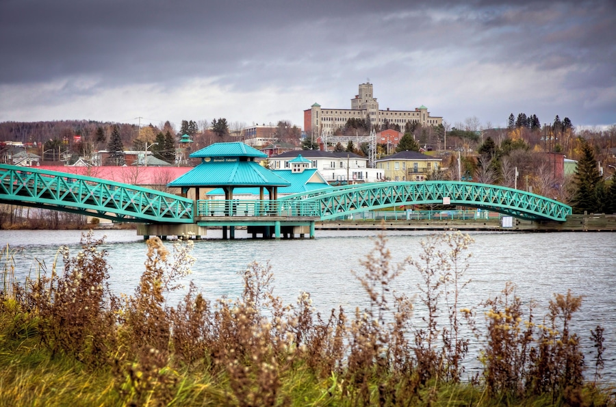 Bridge over river in Edmundston with University of Moncton in background, Edmundston