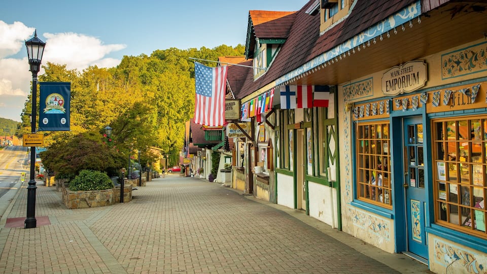 A historic Main Street with traditional architecture, American flags, and a sign for the Emporium.