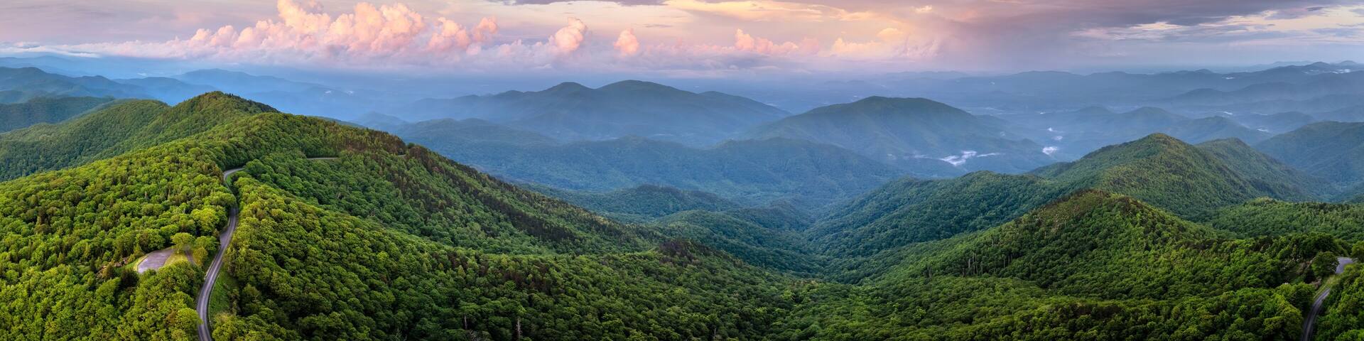 Evening mountain landscape of forest road in North Carolina Appalachians, USA. Blue Ridge Parkway American highway in summer season