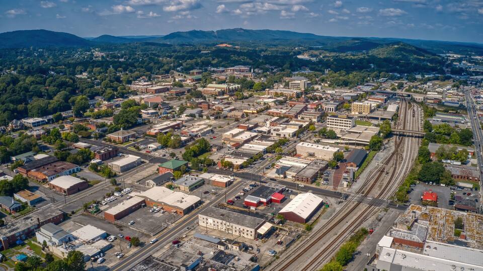An aerial view of a city with a railway track running through it.