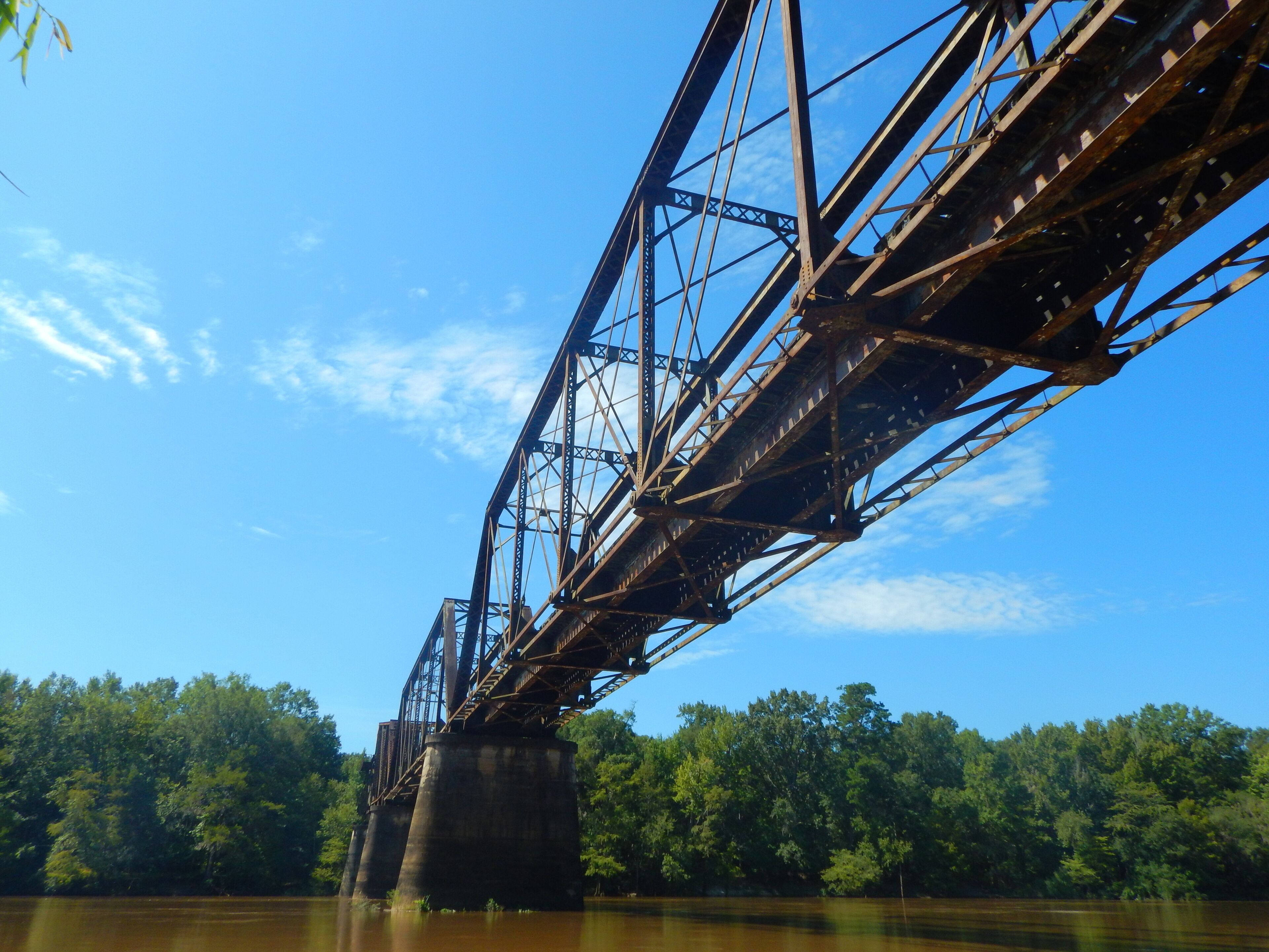 Beautiful rusted abandoned train bridge ruin crosses over the Altamaha River in South Georgia