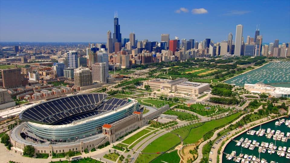A city skyline with a large stadium and marina.