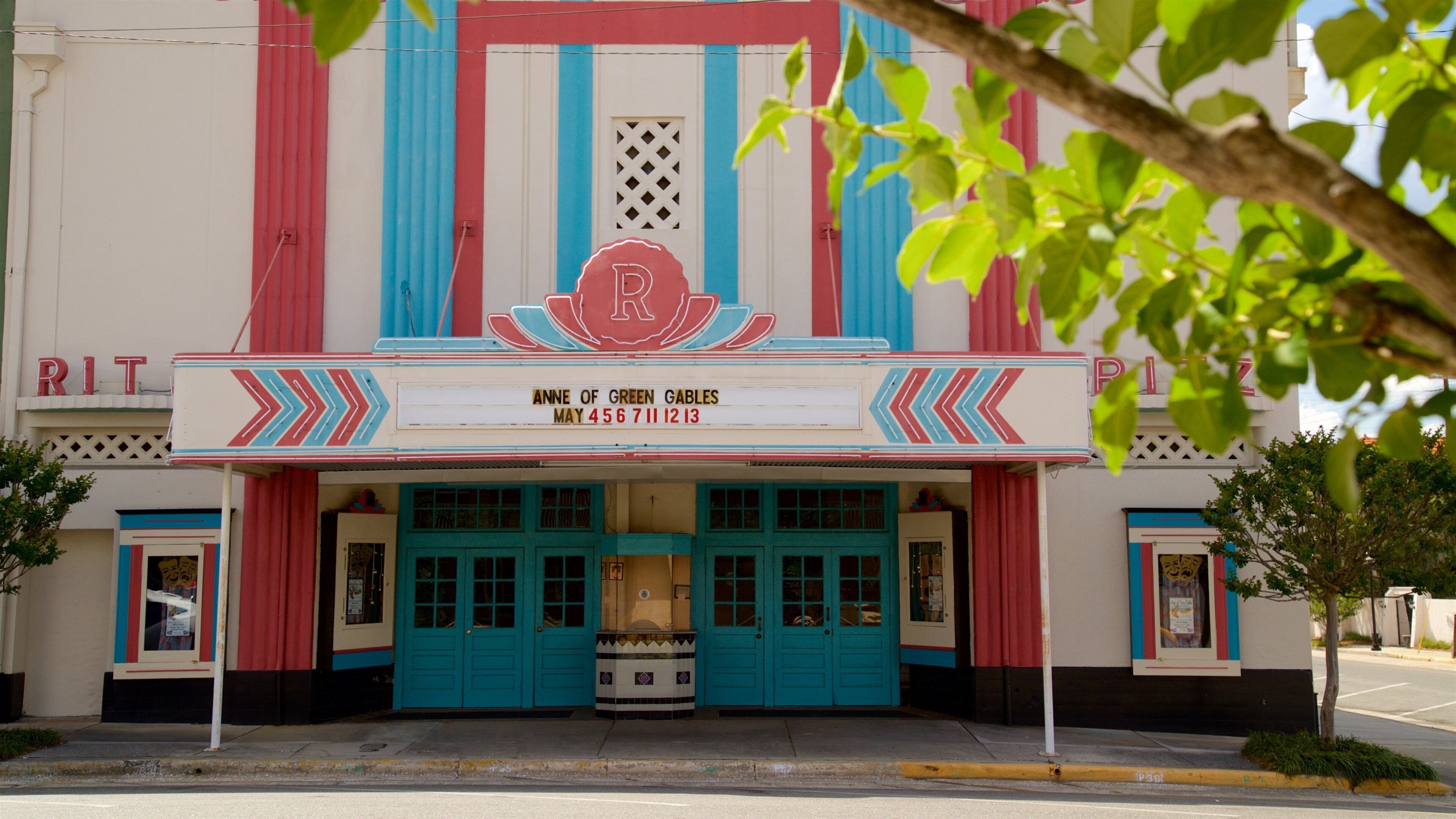 A theater with turquoise doors and a sign reading "Anne of Green Gables".