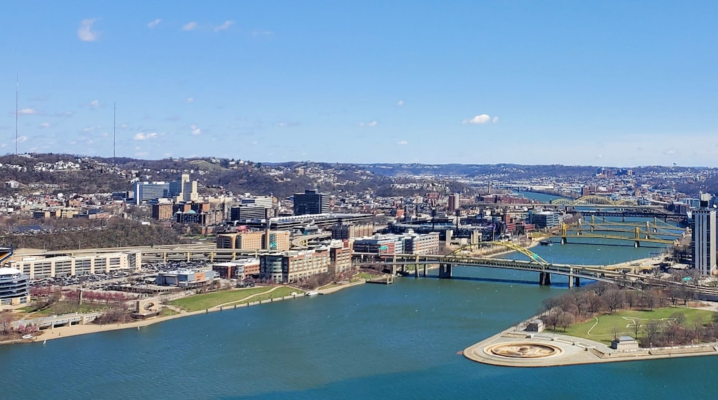 Pittsburgh, Pennsylvania, USA – April 10, 2024: Panoramic view of Point State Park where the Allegheny and Monongahela Rivers meet to form the Ohio River, with Acrisure Stadium and downtown in view.