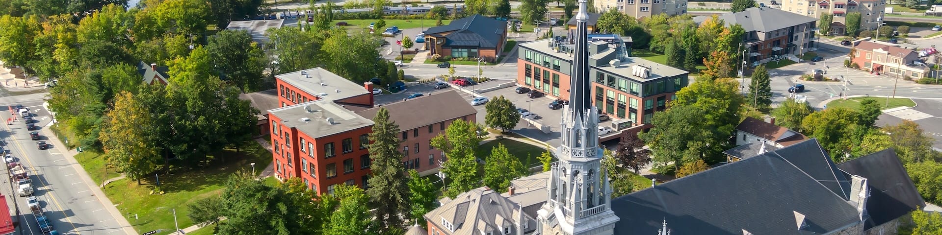 A town with a prominent church, a lake, and surrounding greenery.