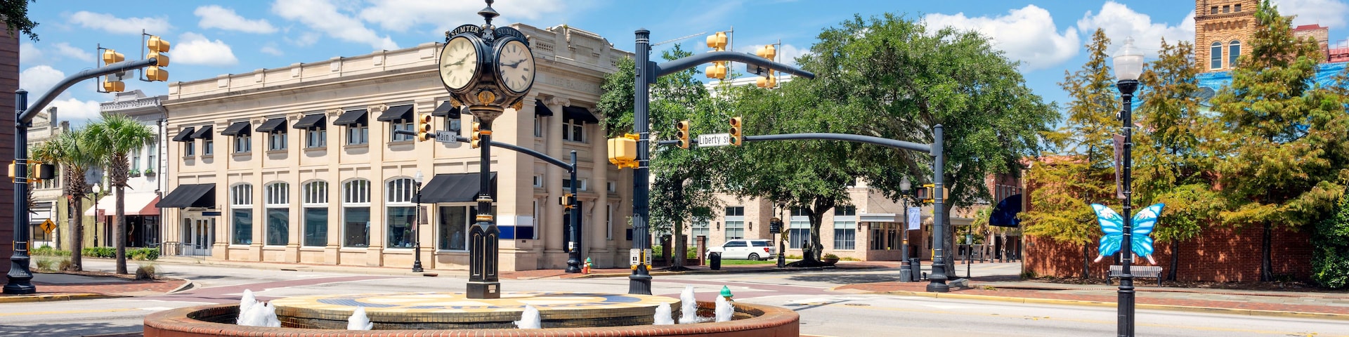 The historic Main Street corner clock tower with the Opera House Clock Tower behind, in the picturesque historic downtown of Sumter, South Carolina, in the Southeast USA.