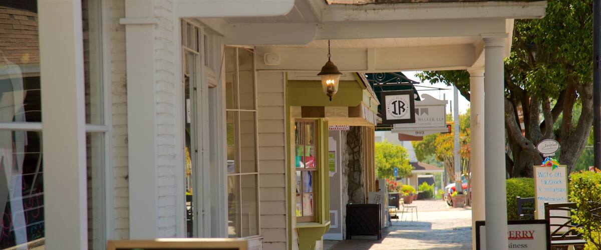 A sidewalk with a sign that reads "Swing on by!" and another sign indicating "Initial Reaction" and "We're on Facebook & Instagram."