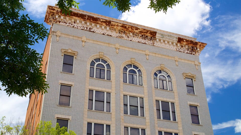 A multi-story building with arched windows and a brick facade.