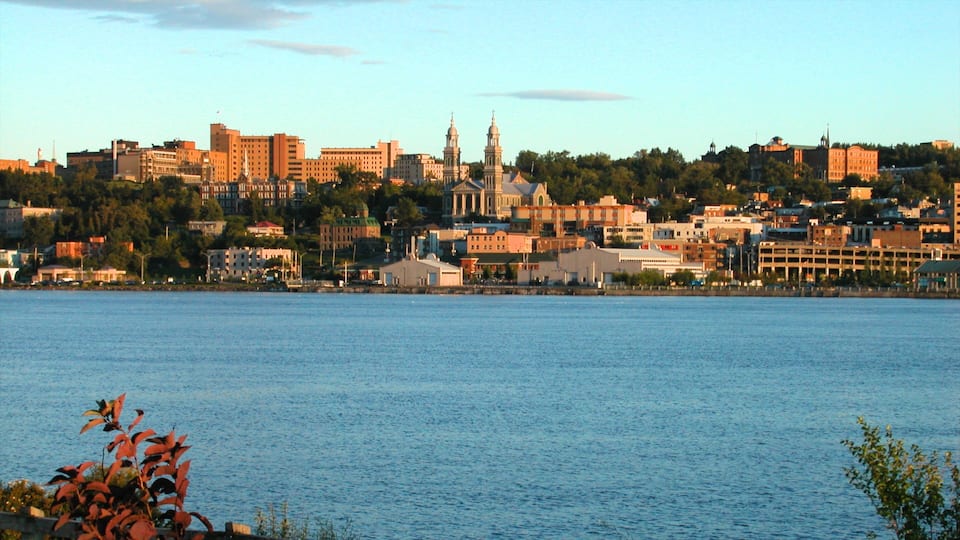 A coastal cityscape with a prominent church and various buildings along the waterfront.