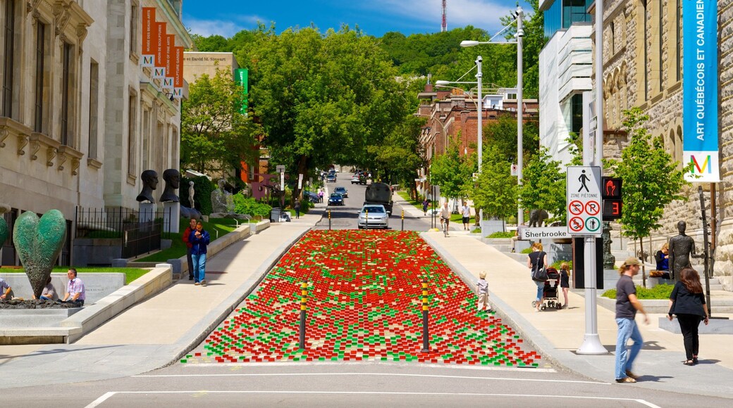 Downtown Montreal featuring outdoor art, a city and street scenes