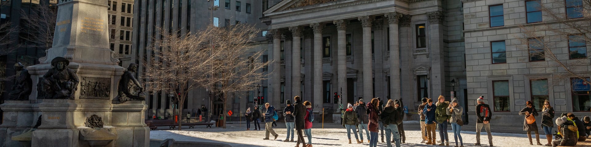 Old Montreal featuring a city, street scenes and an administrative buidling