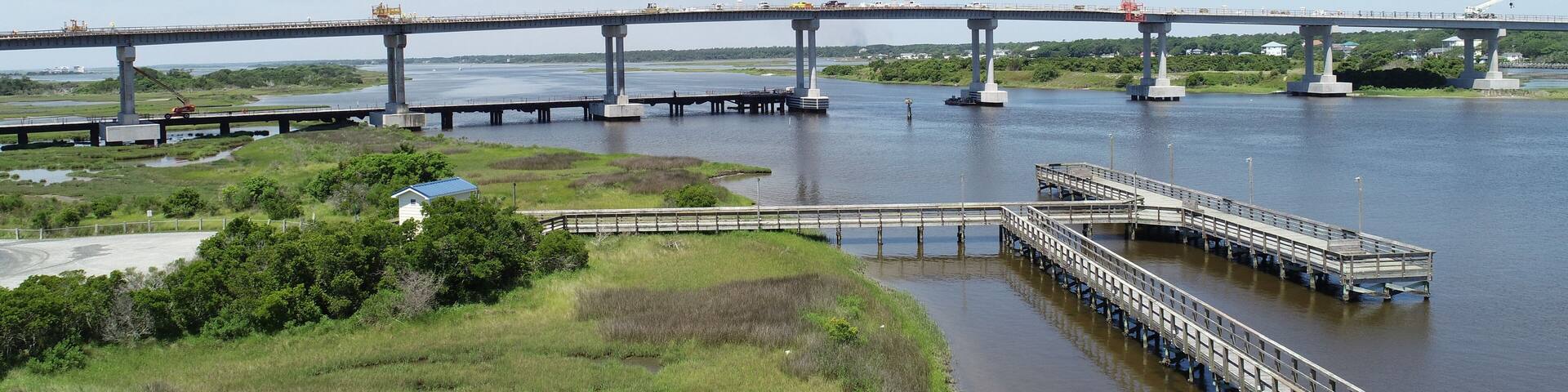 Pier with bridge construction in the distance.