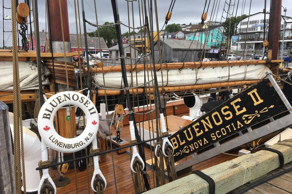 A ship's deck with ropes, a lifebuoy, and a sign reading "Bluenoose I Nova Scotia".