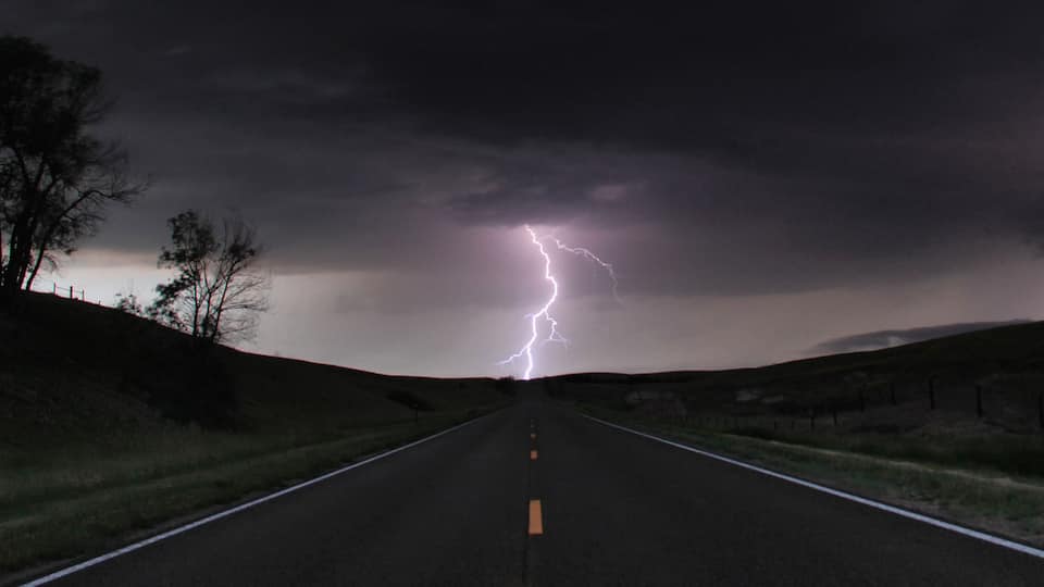 A road leading to a lightning strike in a rural area.