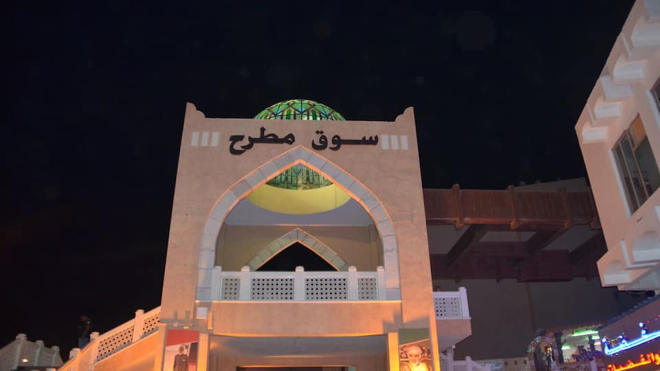 A mosque with a large dome and arched entrance.