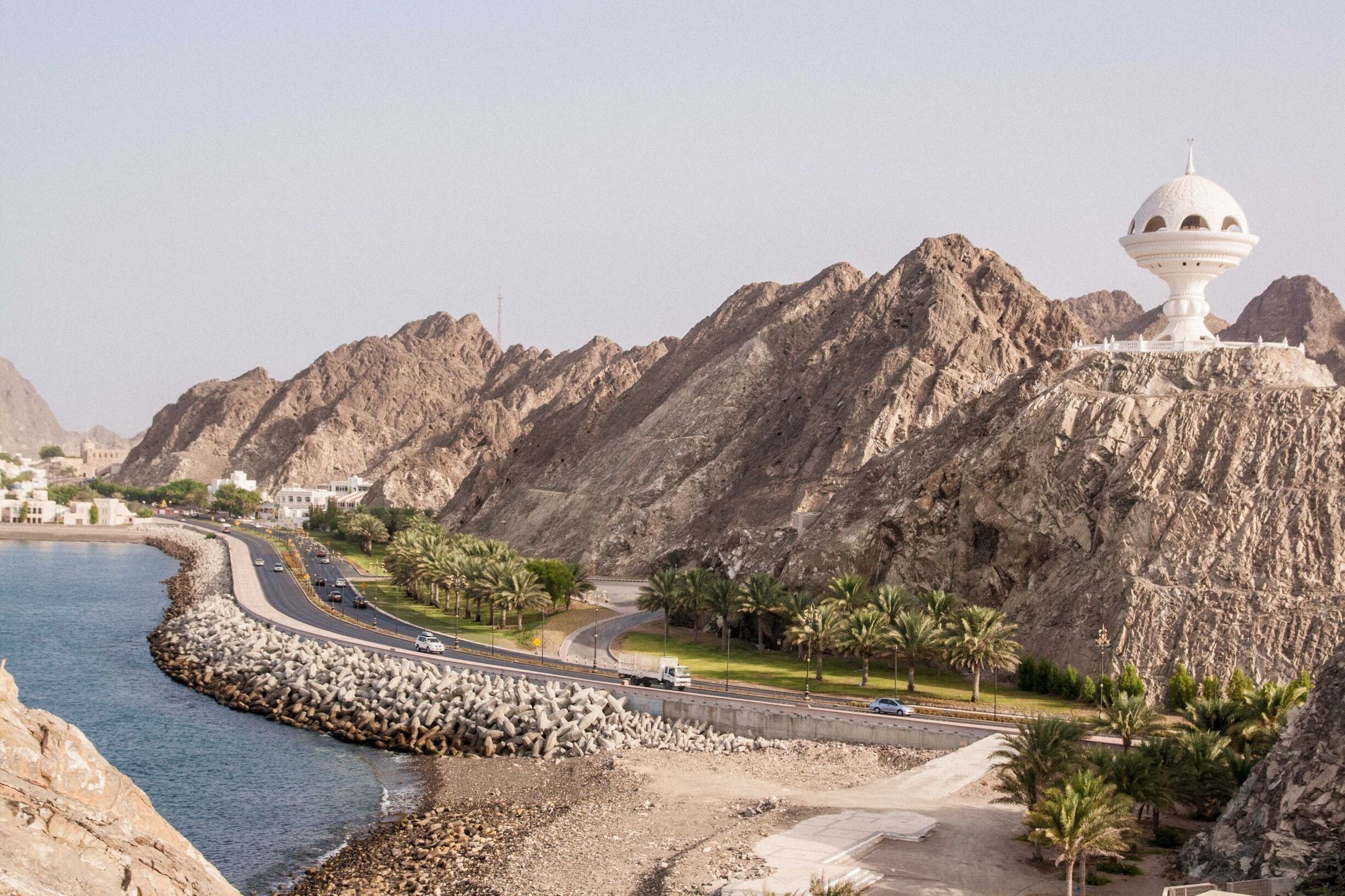 The road to Old #Muscat, #Oman    🇴🇲, with the ancient city walls on the left and the giant incense burner on the right. View from the Old Watchtower, which protected #Muttrah Harbour.
#LifeAtExpedia
#TroveOnTuesday