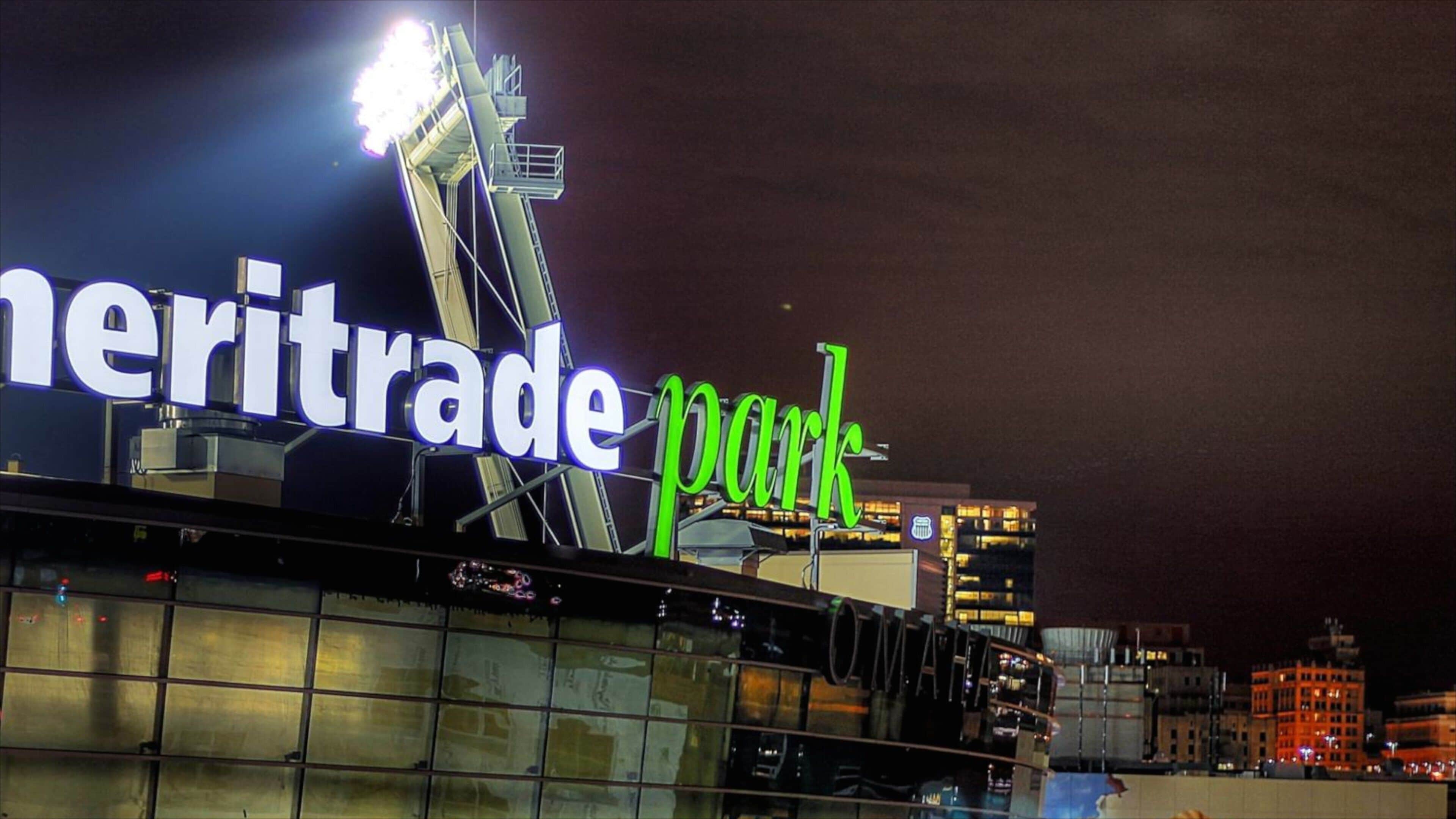 A nighttime view of the Meritrade Park sign with illuminated letters against a dark sky.