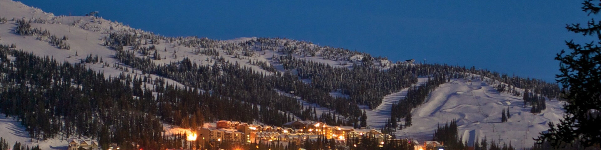 Big White Ski Resort showing night scenes, a small town or village and snow
