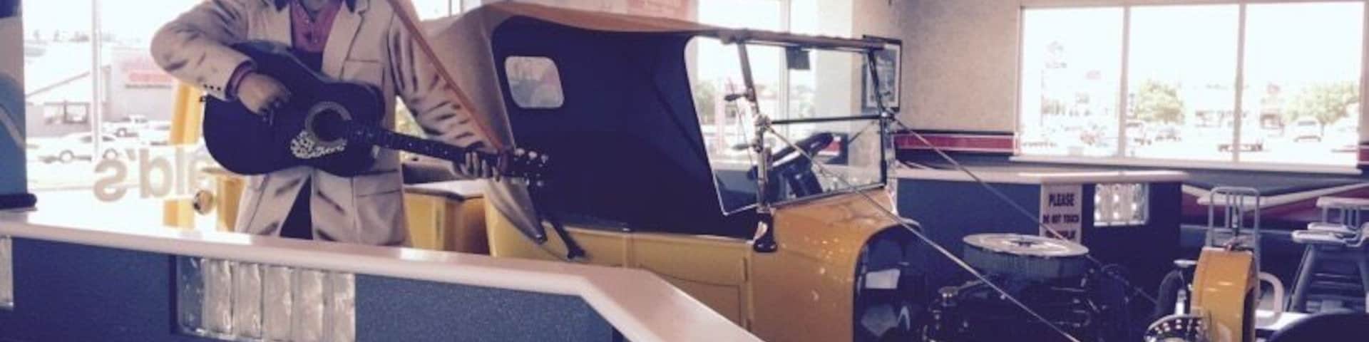 Who knew Topeka rated such a fancy theme McDonald's? If life throws you a situation where you have to eat McD's at least you can do it in style with Elvis and a sweet hot rod! Also many other vintage items, neon, and murals of muscle cars at the drive in on every wall.