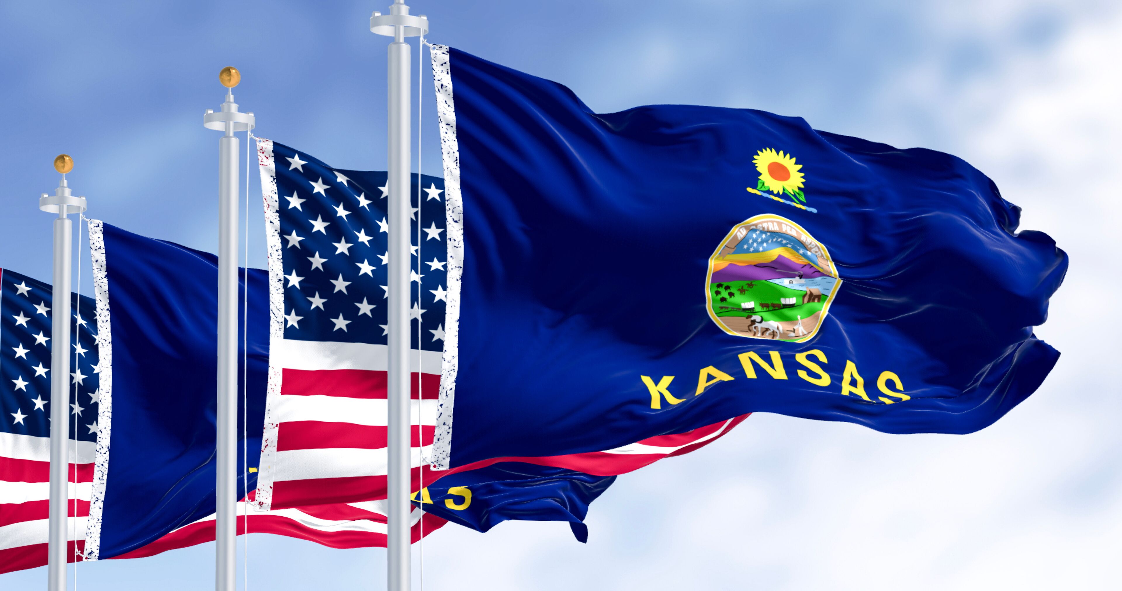 The Kansas state flag with the state emblem and the American flag.
