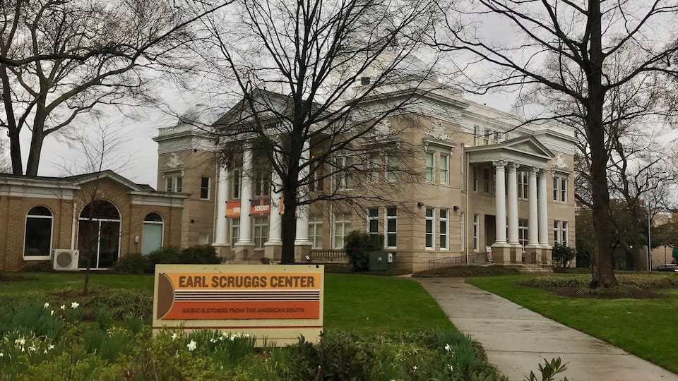 A building with a sign reading "Earl Scruggs Center" in front.