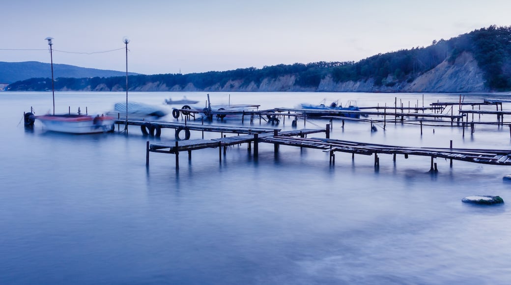 Fishing boats and the pier. Long exposure seascape during sunset, blue hour in the harbour near Byala, Bulgaria.