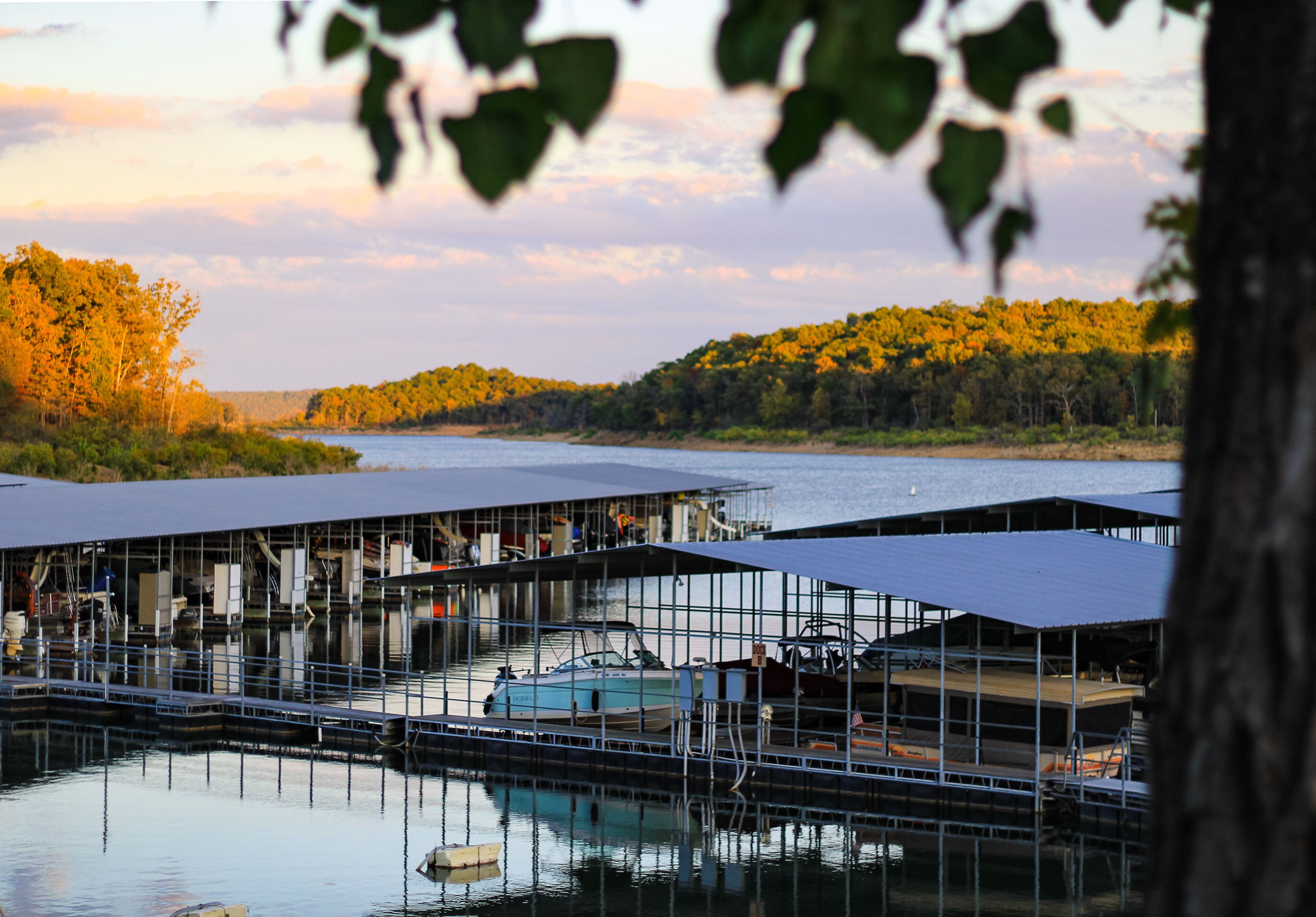 Looking out over Norfork Lake and Buzzard Roost Marina in Mountain Home, AR on a beautiful evening as the sun is setting in the background 