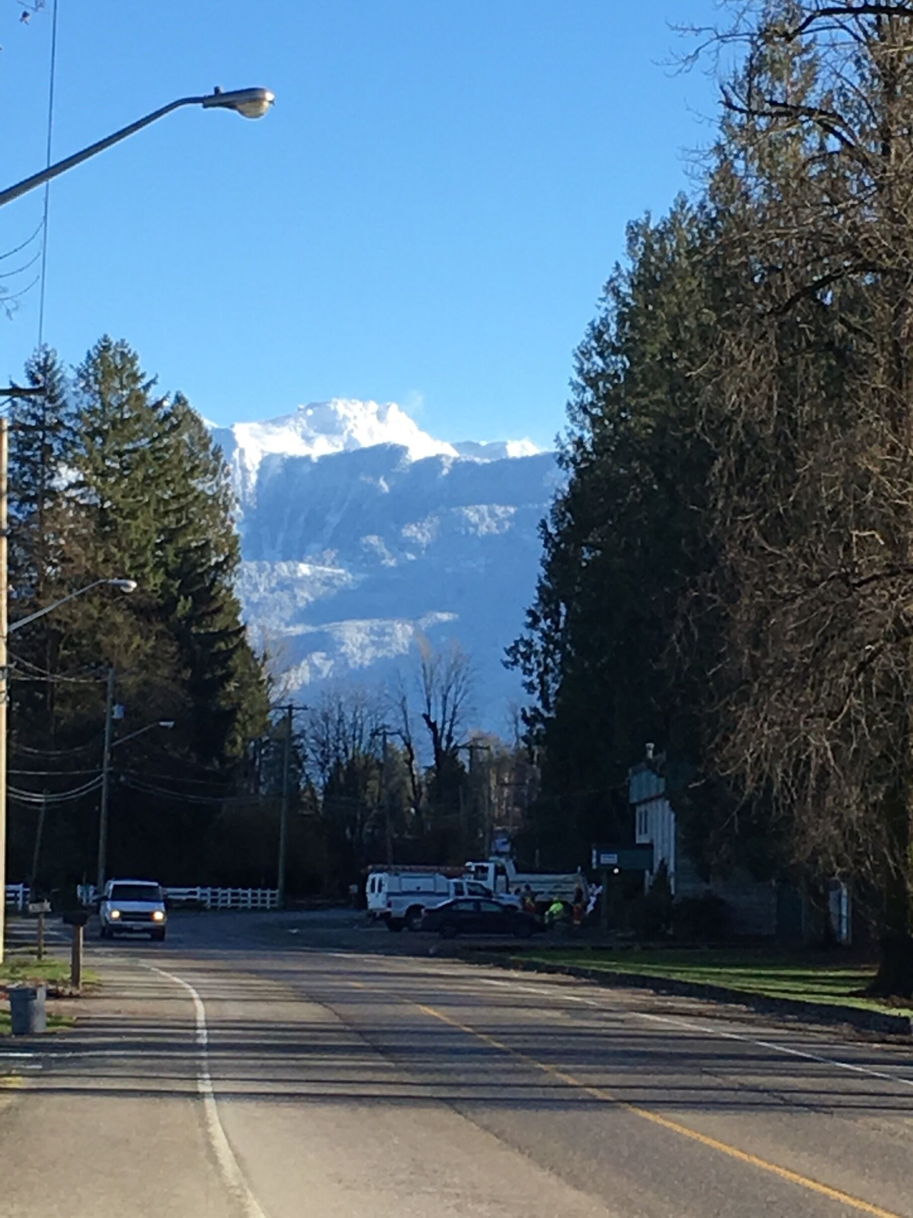 A road with a mountain in the background.