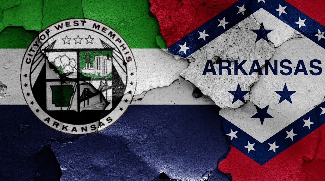 flags of West Memphis and Arkansas painted on cracked wall
