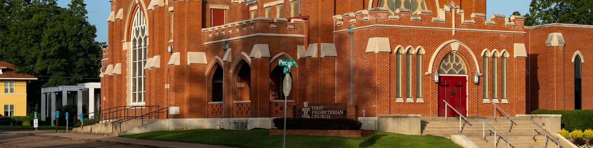 A large brick church with a prominent tower and arched windows.