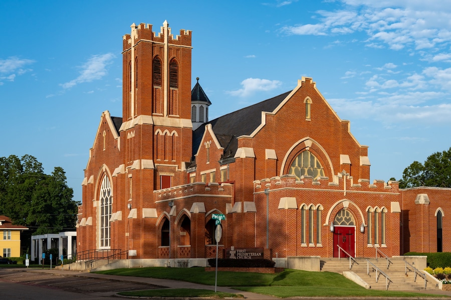 A large brick church with a prominent tower and arched windows.