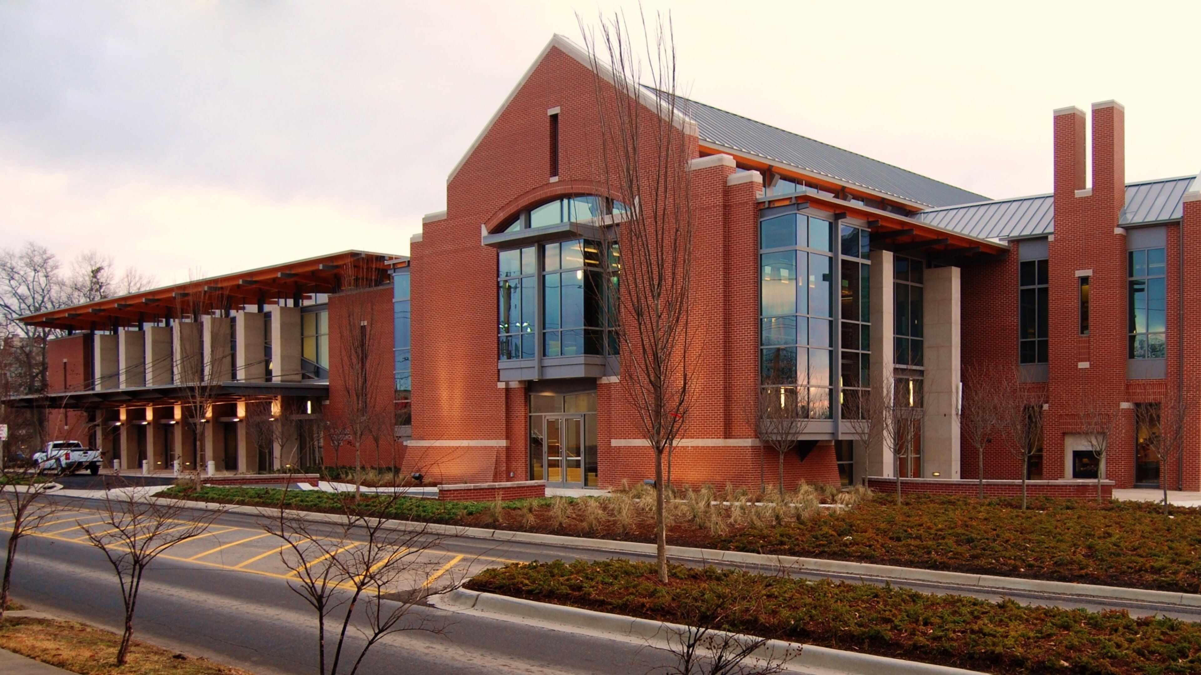 A modern building with red brick walls and large windows.