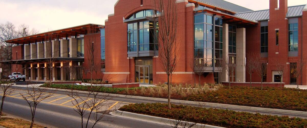 A modern building with red brick walls and large windows.