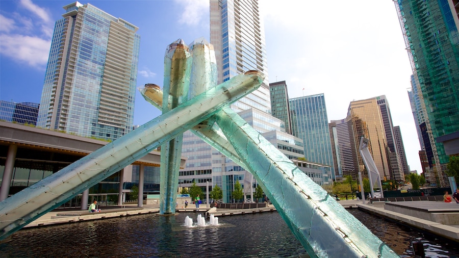 Downtown Vancouver which includes outdoor art, a city and a fountain
