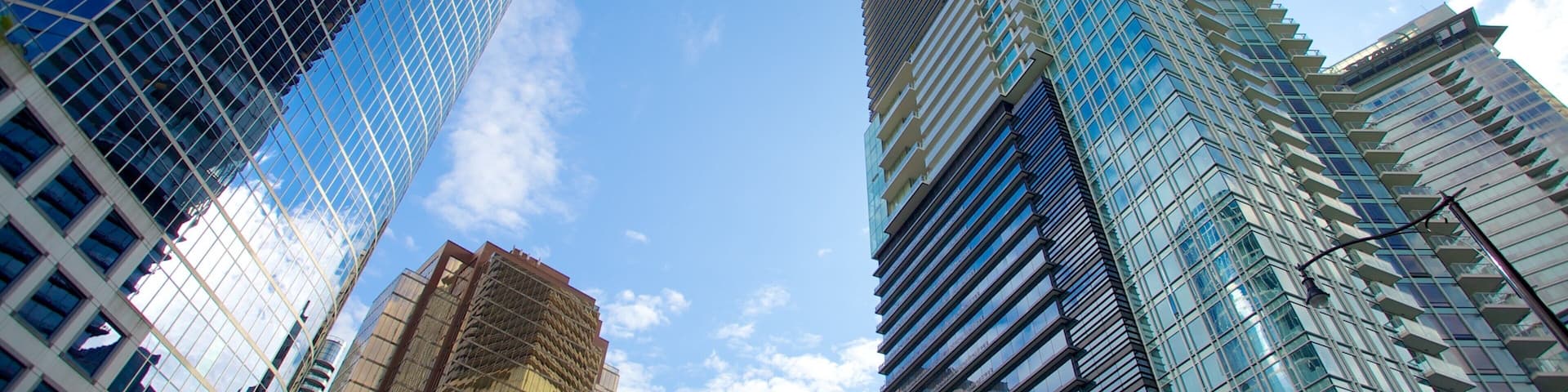 A cityscape with tall skyscrapers and a clear blue sky.