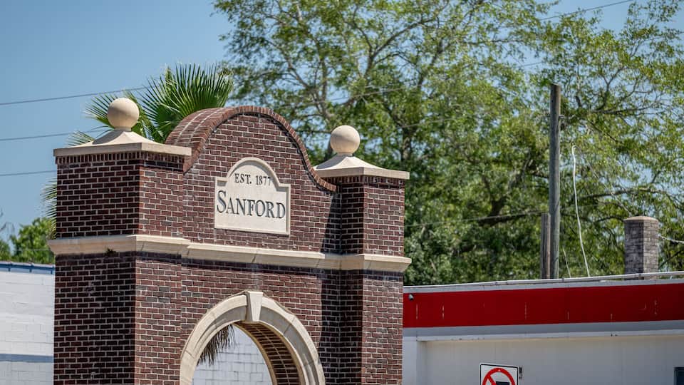 A brick building with a sign that reads "Sanford EST. 1877".