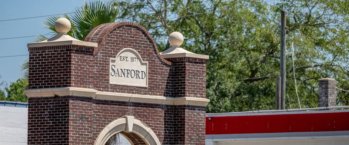 A brick building with a sign that reads "Sanford EST. 1877".