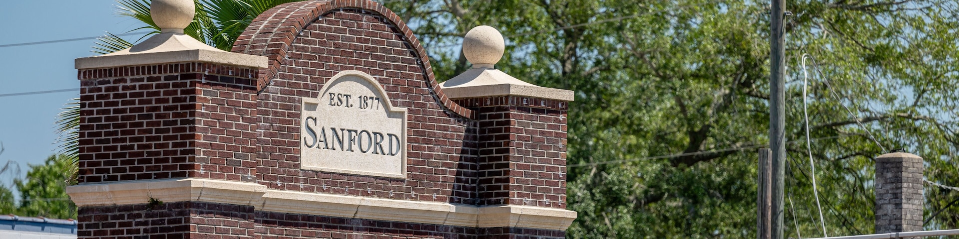 A brick building with a sign that reads "Sanford EST. 1877".