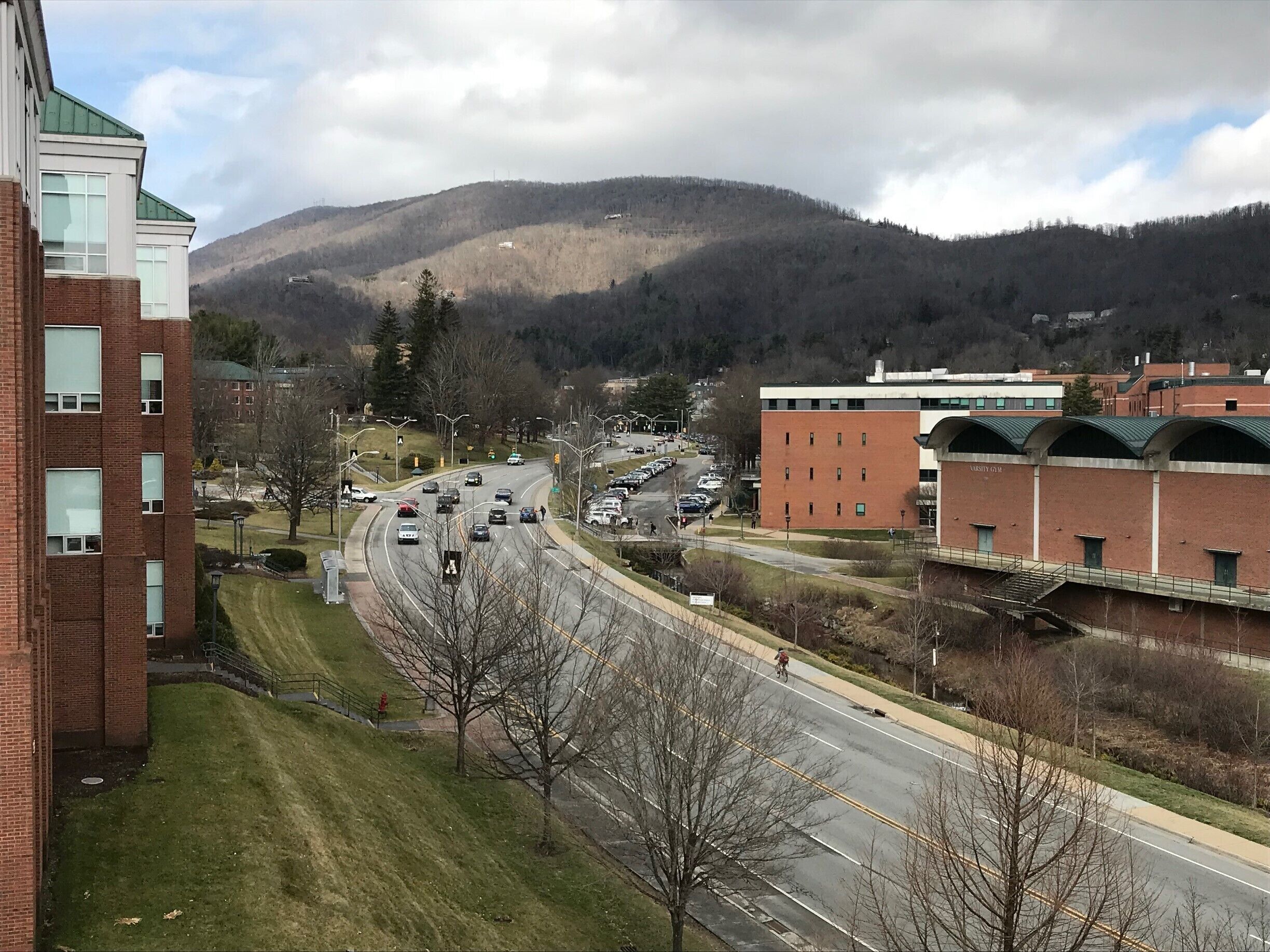 #appalachianechoes
I took this image from the River Street Parking Deck. It is of traffic on Appalachian State University Campus with the mountains behind it all, dotted with a few houses. For me, it captures an ever-increasing place of learning, nestled within Appalachia and one type of resident that calls the mountains home. This picture holds just a small part of everyday life that happens in the Appalachia region. 
