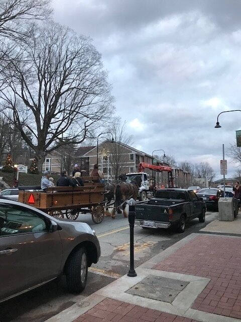 This photograph was taken on King Street in downtown Boone, North Carolina. I took this picture on Friday, December 1, which was the day of the Christmas Tree lighting in Boone. The streets were filled with people, both residents and visitors, as well as numerous vendors. The atmosphere was very festive and cheery. King Street is always very crowded, but the area was even more packed for the Christmas Tree lighting. In the photograph, there is a horse-drawn carriage with a family in the back. This image reflects aspects of a time gone by. The growing modernity of the Appalachian region, specifically Boone, is evident in the cars lining the street, the condos looming in the background, and the construction truck driving in the opposite direction of the carriage. The construction truck represents the growing industrialization and shift away from rural in the region. This clash of old and new is still an ongoing battle in Appalachia. It is interesting that the carriage is heading in the direction of Highway 421, which represents a more modern region, while the construction truck is driving towards Highway 321, which reflects a much more agrarian landscape. Although there is an ongoing battle for the future of Appalachia, the two sides (old and new) are coexisting fairly well thus far. #appalachianechoes