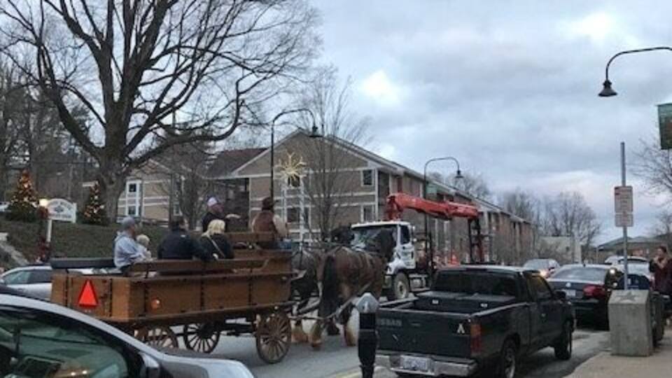 This photograph was taken on King Street in downtown Boone, North Carolina. I took this picture on Friday, December 1, which was the day of the Christmas Tree lighting in Boone. The streets were filled with people, both residents and visitors, as well as numerous vendors. The atmosphere was very festive and cheery. King Street is always very crowded, but the area was even more packed for the Christmas Tree lighting. In the photograph, there is a horse-drawn carriage with a family in the back. This image reflects aspects of a time gone by. The growing modernity of the Appalachian region, specifically Boone, is evident in the cars lining the street, the condos looming in the background, and the construction truck driving in the opposite direction of the carriage. The construction truck represents the growing industrialization and shift away from rural in the region. This clash of old and new is still an ongoing battle in Appalachia. It is interesting that the carriage is heading in the direction of Highway 421, which represents a more modern region, while the construction truck is driving towards Highway 321, which reflects a much more agrarian landscape. Although there is an ongoing battle for the future of Appalachia, the two sides (old and new) are coexisting fairly well thus far. #appalachianechoes
