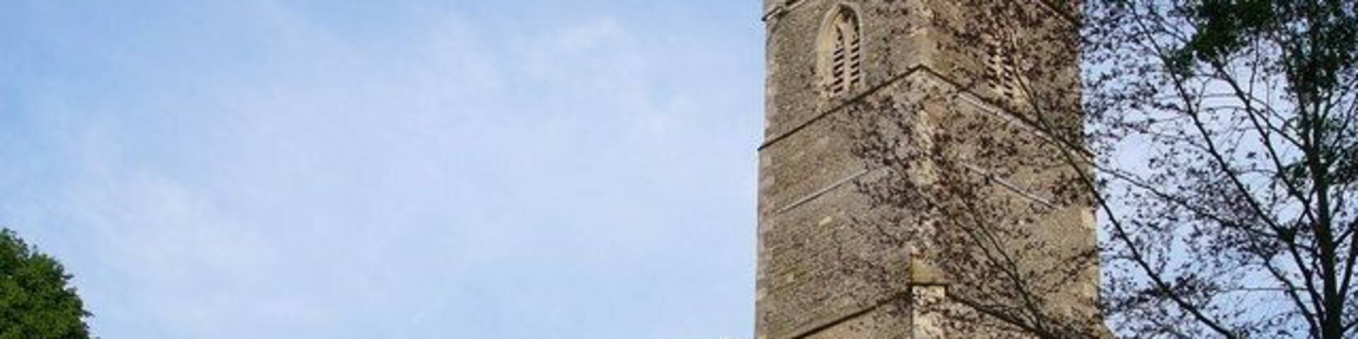 A historic church with a tall tower and arched windows.