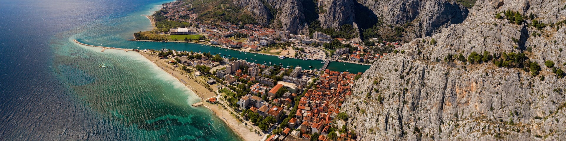 Panorama of town Omis in Croatia - travel background. Aerial drone picture in august 2020