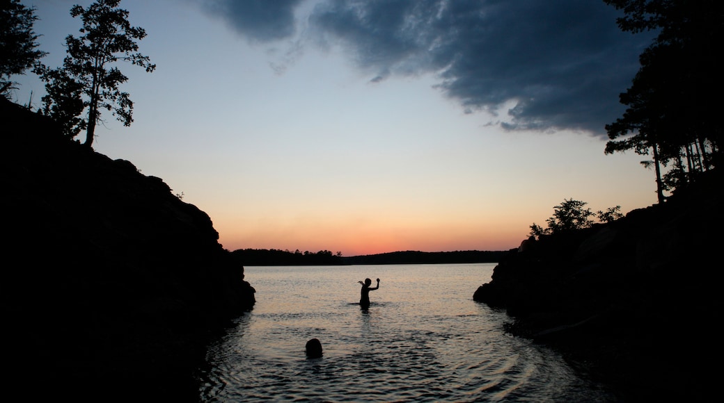Boy throws stone in Lake Ouachita in Arkansas
