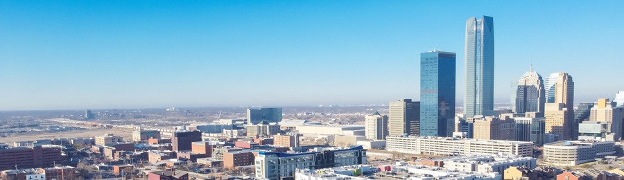 Panorama aerial view downtown Oklahoma City with apartment complex, office buildings, skyscraper business district, residential high-rise condo, urban street sunny clear blue sky winter time