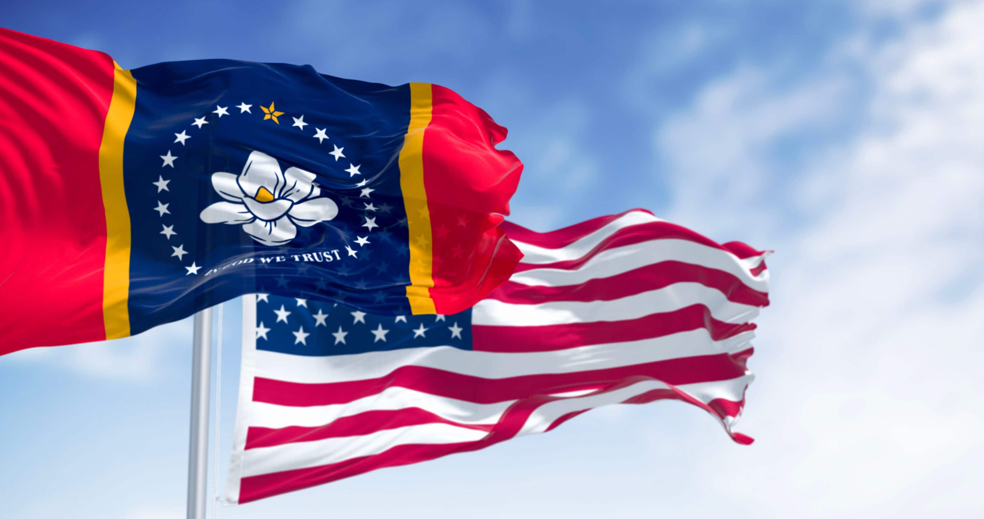 Mississippi state flag waving with the American flag on a clear day. Magnolia state. 3d illustration render. Rippling fabric. Selective focus