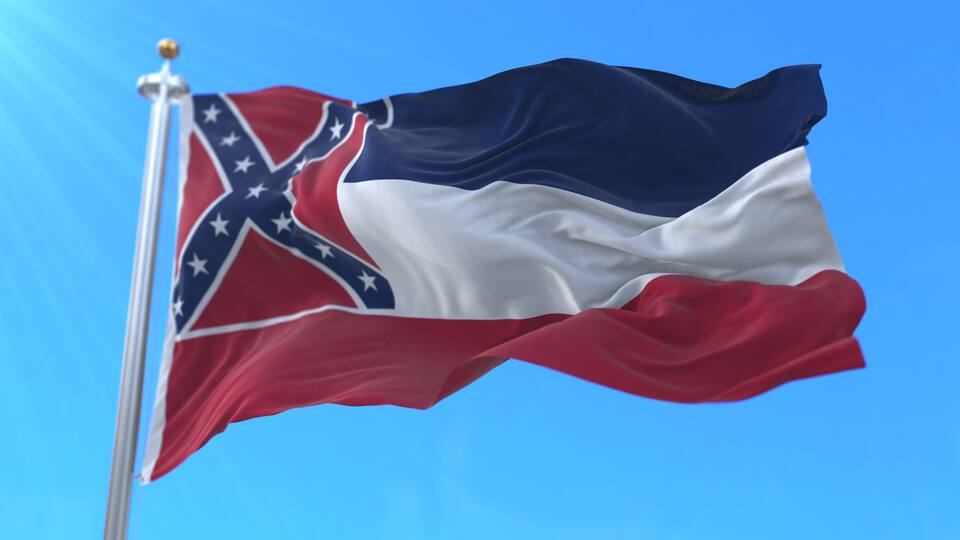 A flag with a blue field, a white cross, and red and white triangles.