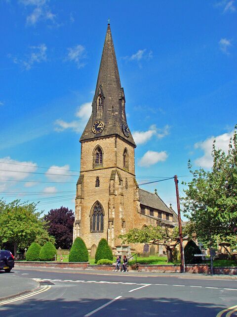 A church with a tall steeple and a clock tower.